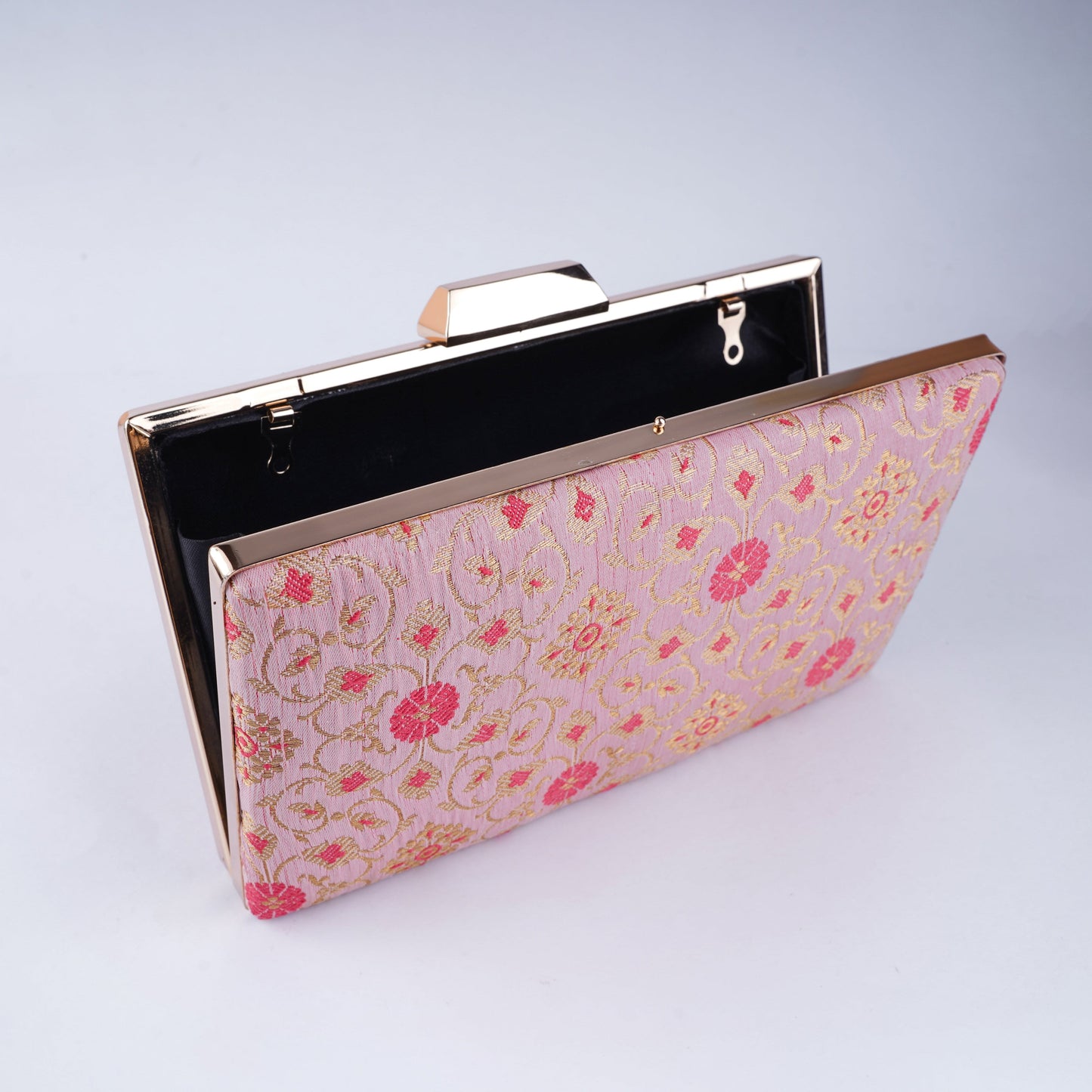 Festive clutch made from rich Banarasi brocade with gold zari detailing – a stylish accessory for bridal and ethnic occasions