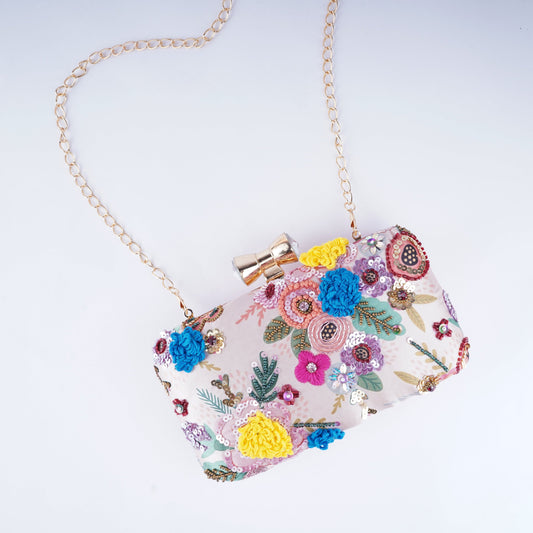 Stylish clutch with floral embroidery over colorful printed base, ideal for festive occasions and celebrations