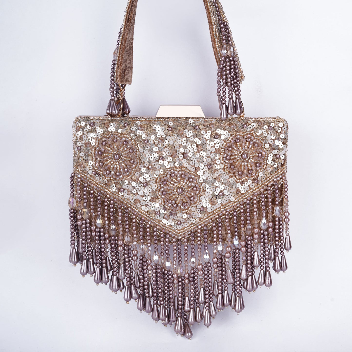 Rectangular clutch with intricate Meena work, sequin and bead embellishments, handcrafted handle, and tassels – available in black, golden, antique, and silver