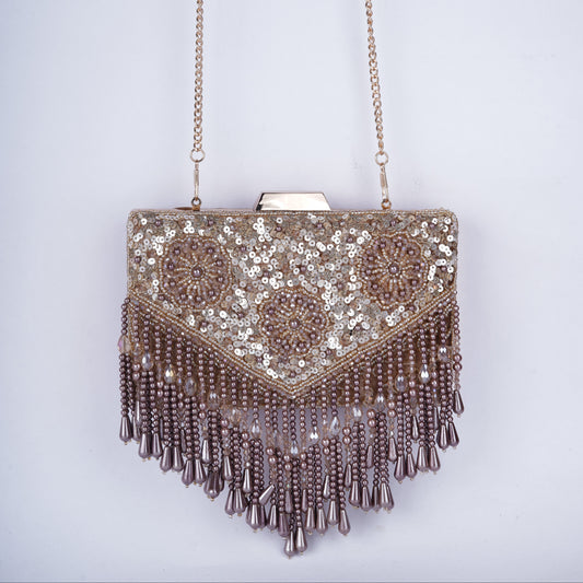 Rectangular clutch beautifully embellished with sequins and drop tassels, featuring a handcrafted handle and detachable chain – available in black, golden, antique, and silver