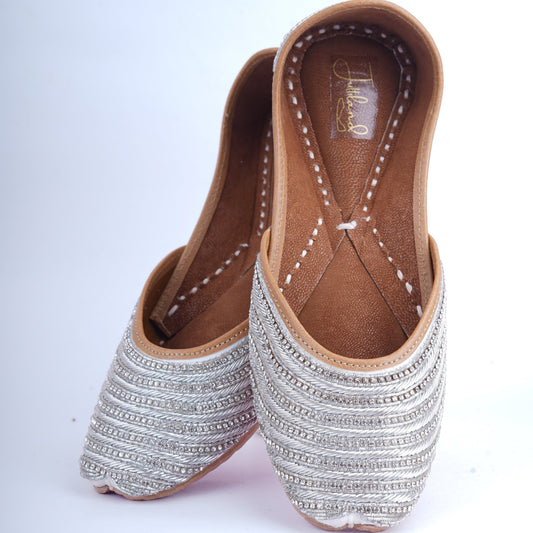Party wear silver jutti for women with hand embroidery and sparkling details
