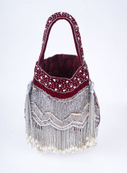 Handmade traditional potli clutch with all-over pearl embellishments, perfect for bridal looks and festive wear