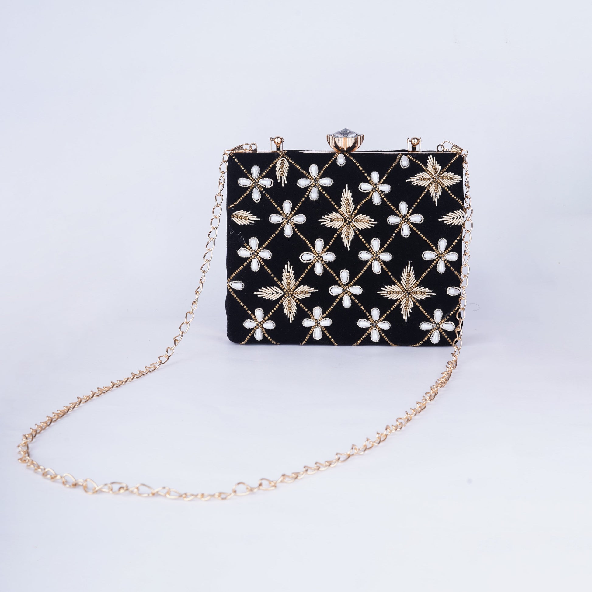 Chic black box clutch with detailed embroidery and a structured silhouette, ideal for ethnic and fusion wear
