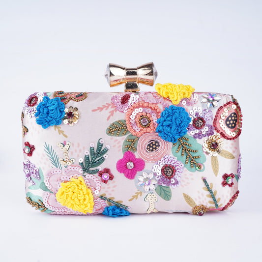 Handcrafted clutch with detailed embroidery on vibrant printed fabric, perfect for ethnic and festive outfits