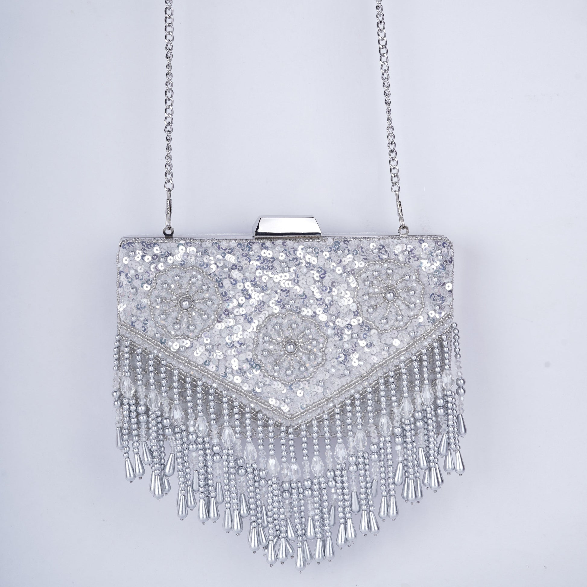 Sequin-embellished rectangle clutch featuring handcrafted detailing, drop tassels, and a detachable chain – comes in black, gold, antique, and silver