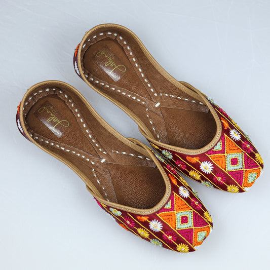 Handcrafted maroon jutti with traditional Phulkari embroidery, inspired by Punjabi culture and festive fashion