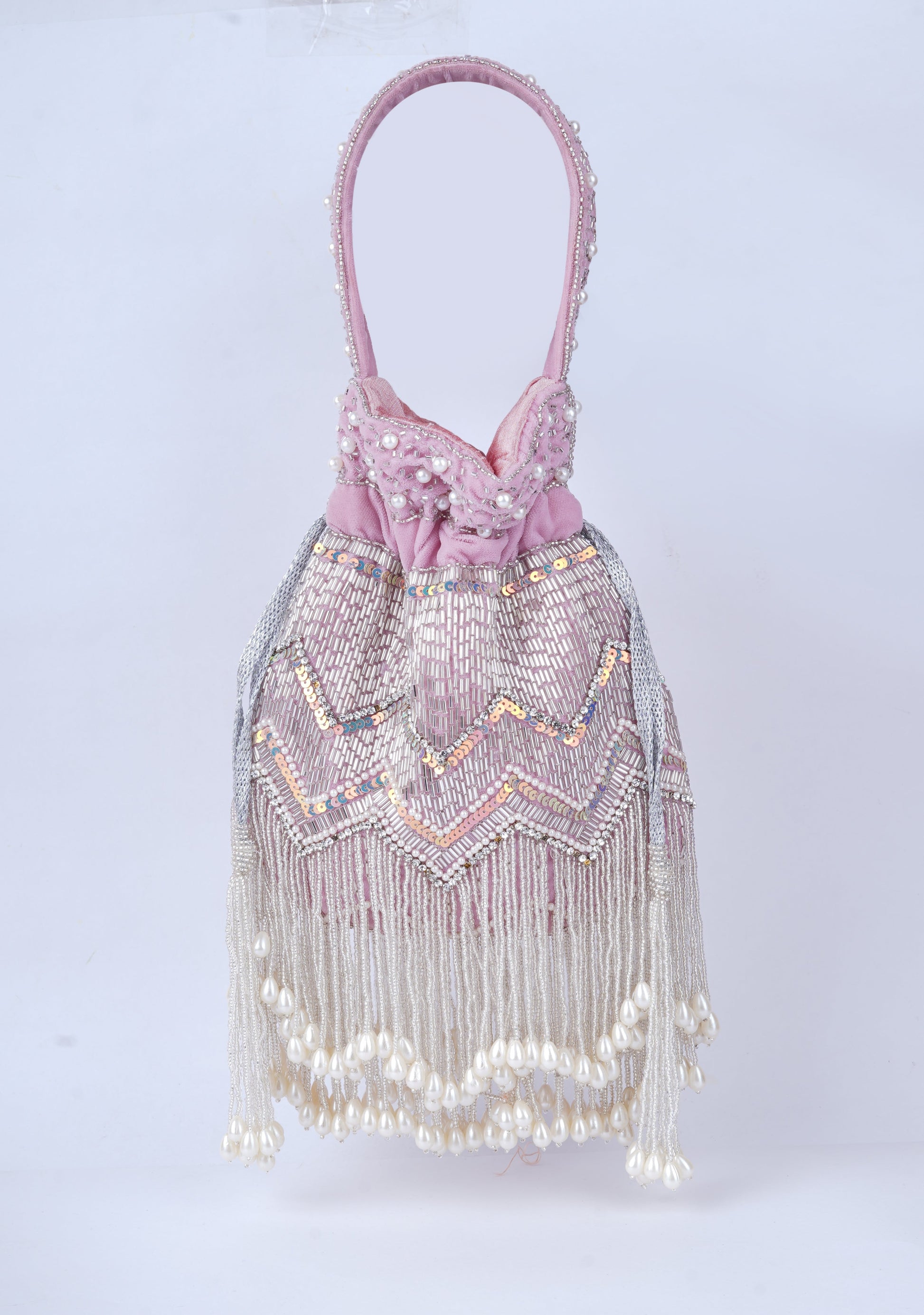 Elegant handcrafted potli bag with intricate pearl embellishments, perfect for weddings and traditional occasions