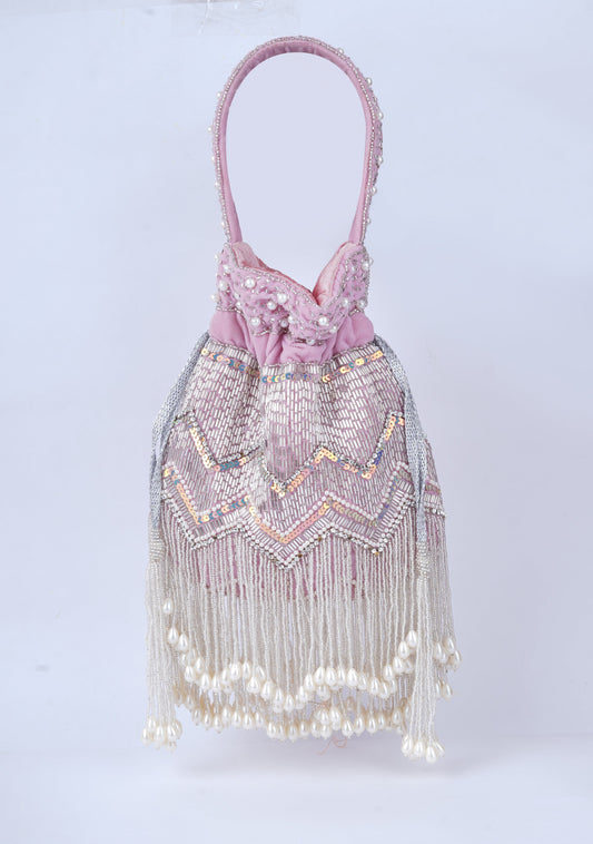 Elegant handcrafted potli bag with intricate pearl embellishments, perfect for weddings and traditional occasions
