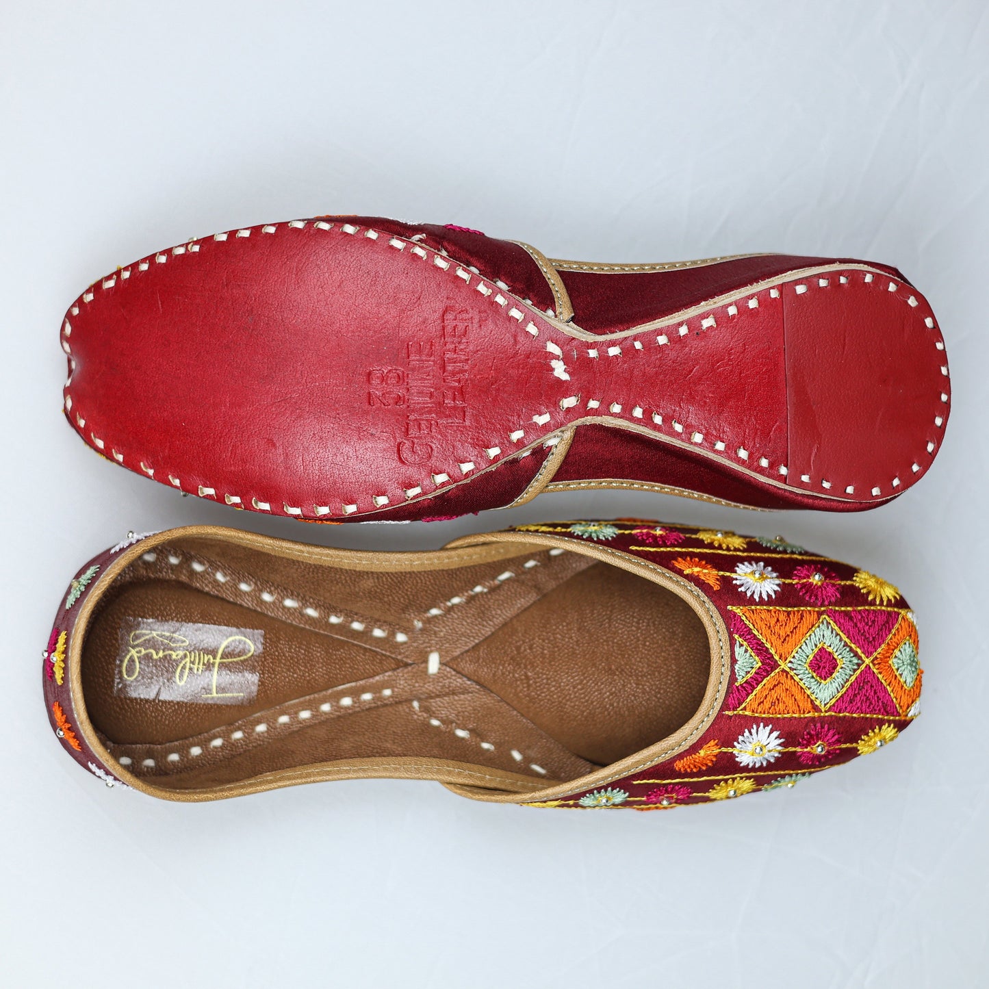 Handcrafted maroon Phulkari jutti with colorful traditional embroidery for women