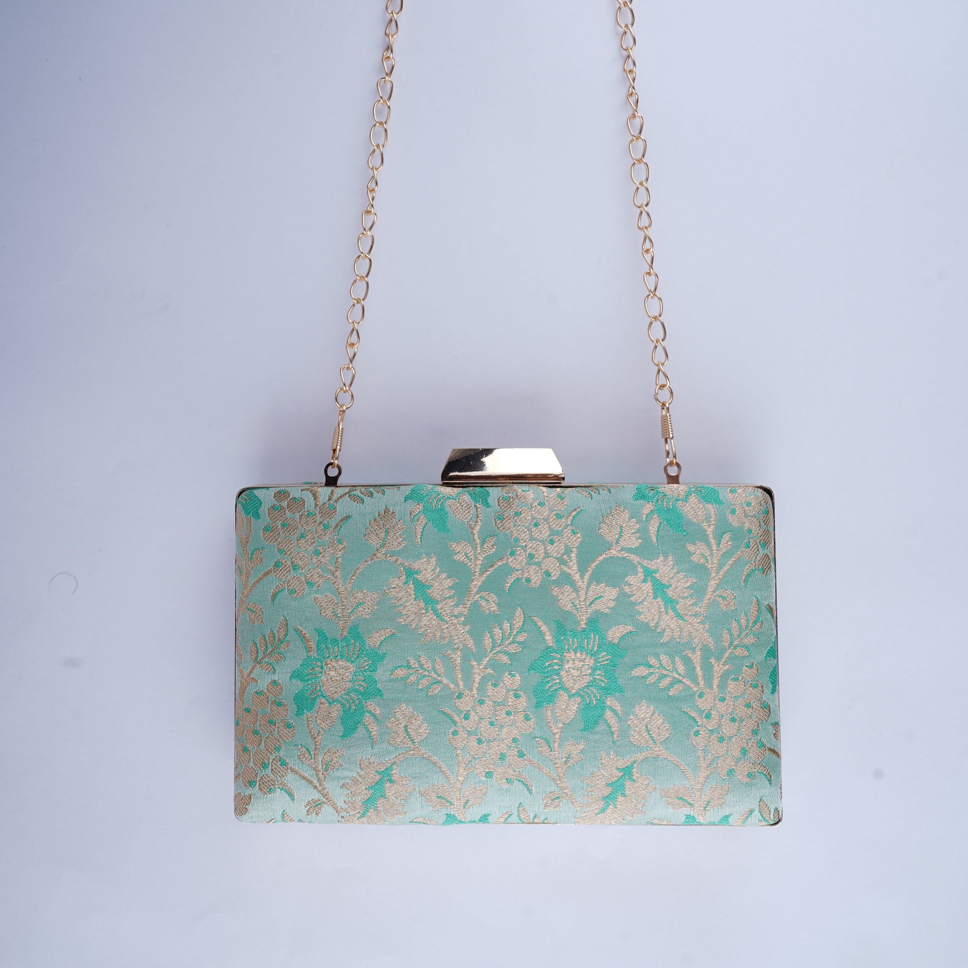 Handcrafted clutch made from traditional Banarasi silk, blending classic design with a modern silhouette for festive and formal use