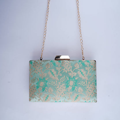 Handcrafted clutch made from traditional Banarasi silk, blending classic design with a modern silhouette for festive and formal use