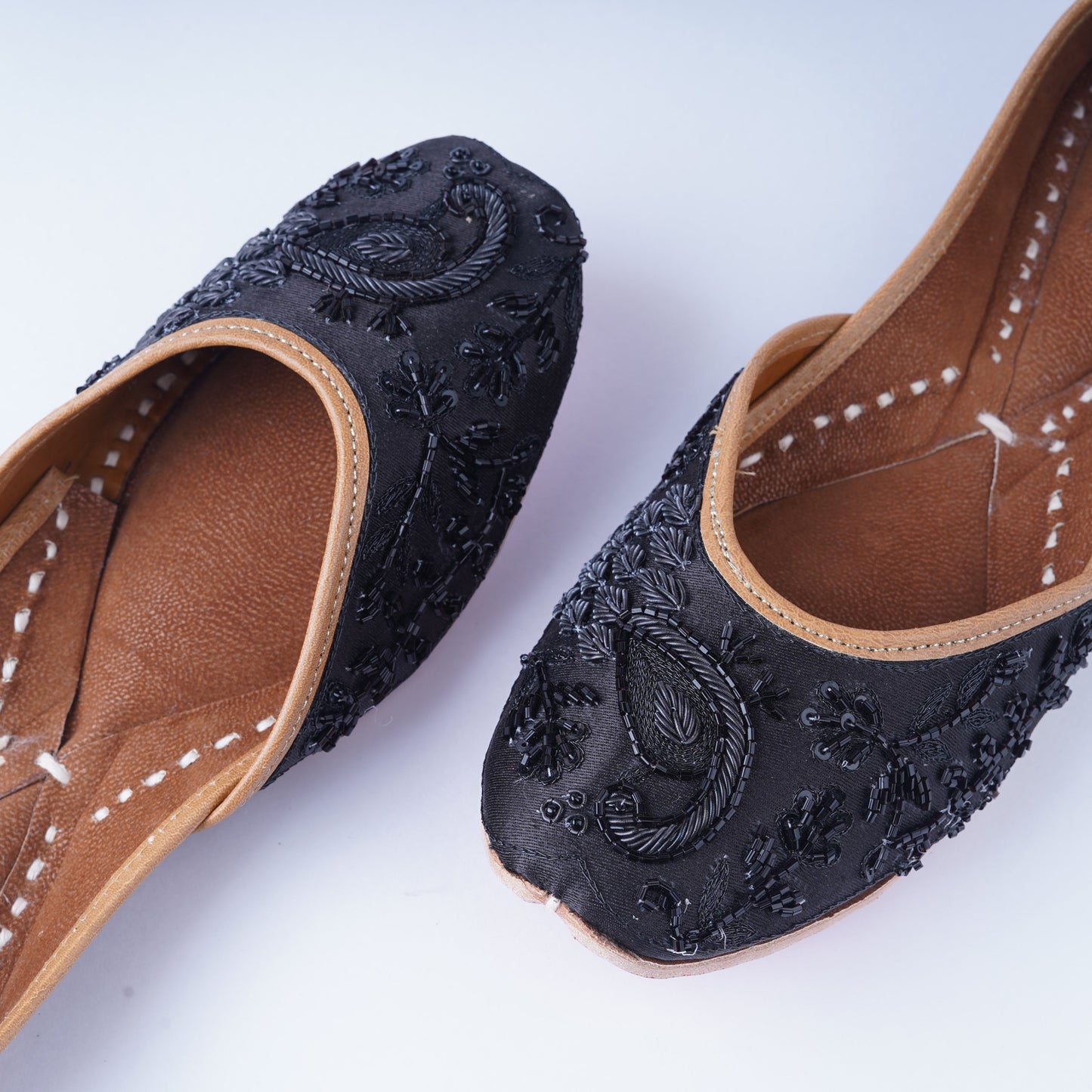 Designer black jutti for women – handcrafted with intricate embellishments
